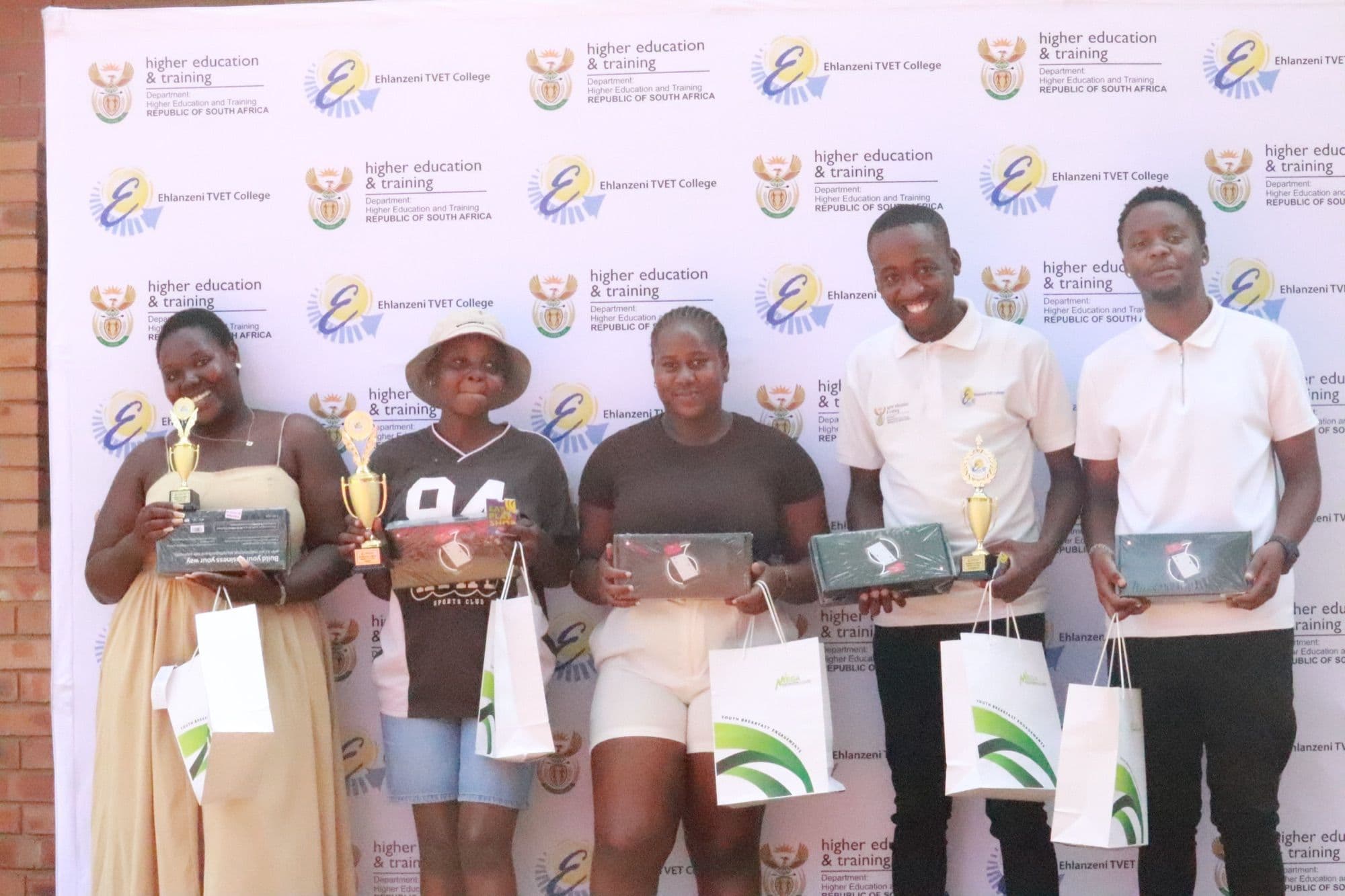 Market Day winners holding their trophies and Vodacom Speedpoint devices
