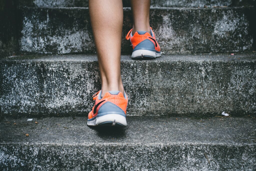 An image of a person wearing running shoes running up some stairs