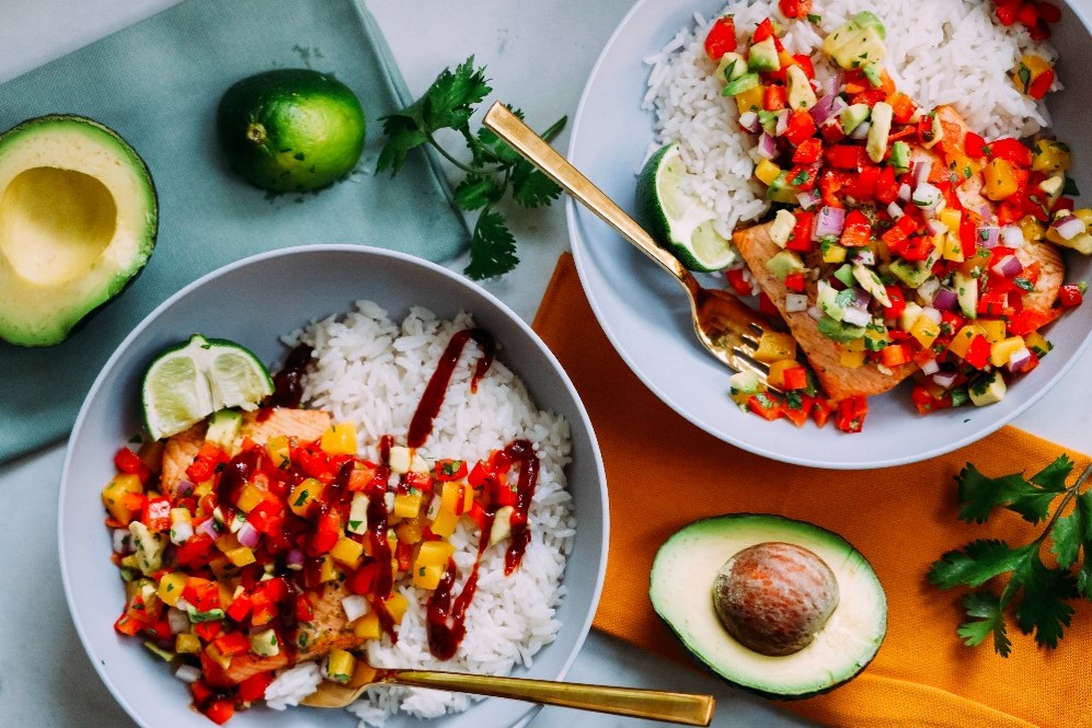 An image of a rice bowl and some cooked veggies