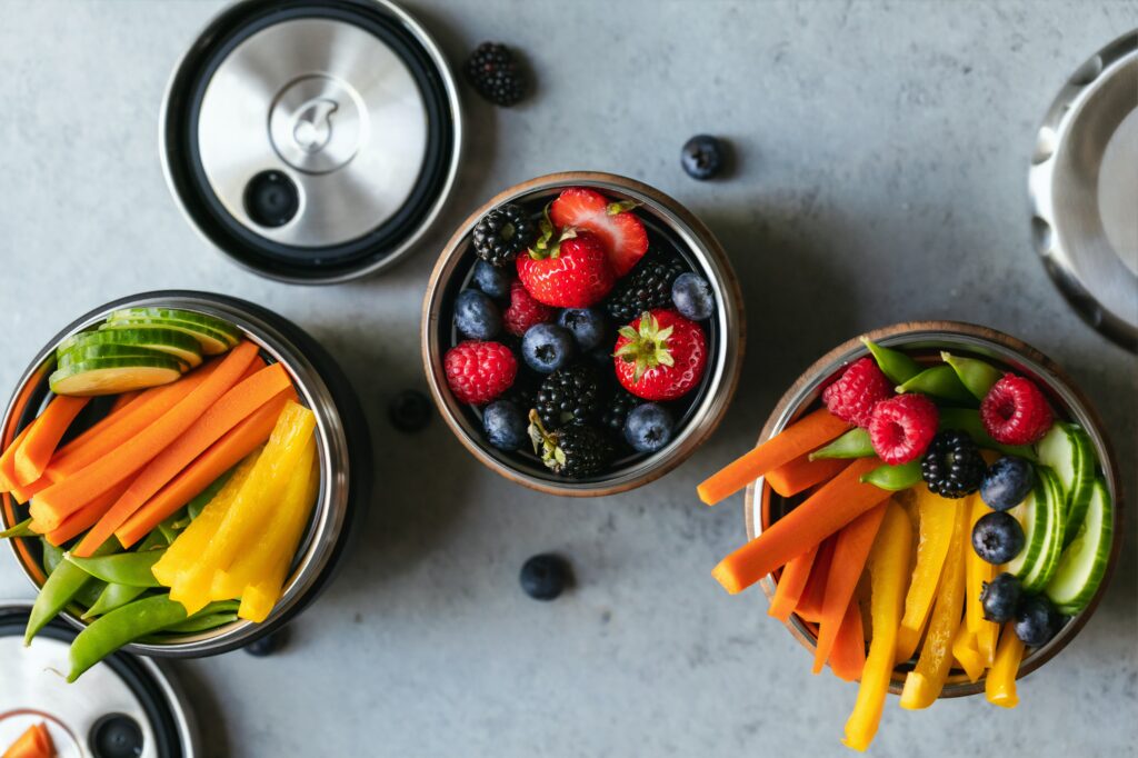 A picture of bowls that have fruits in them.