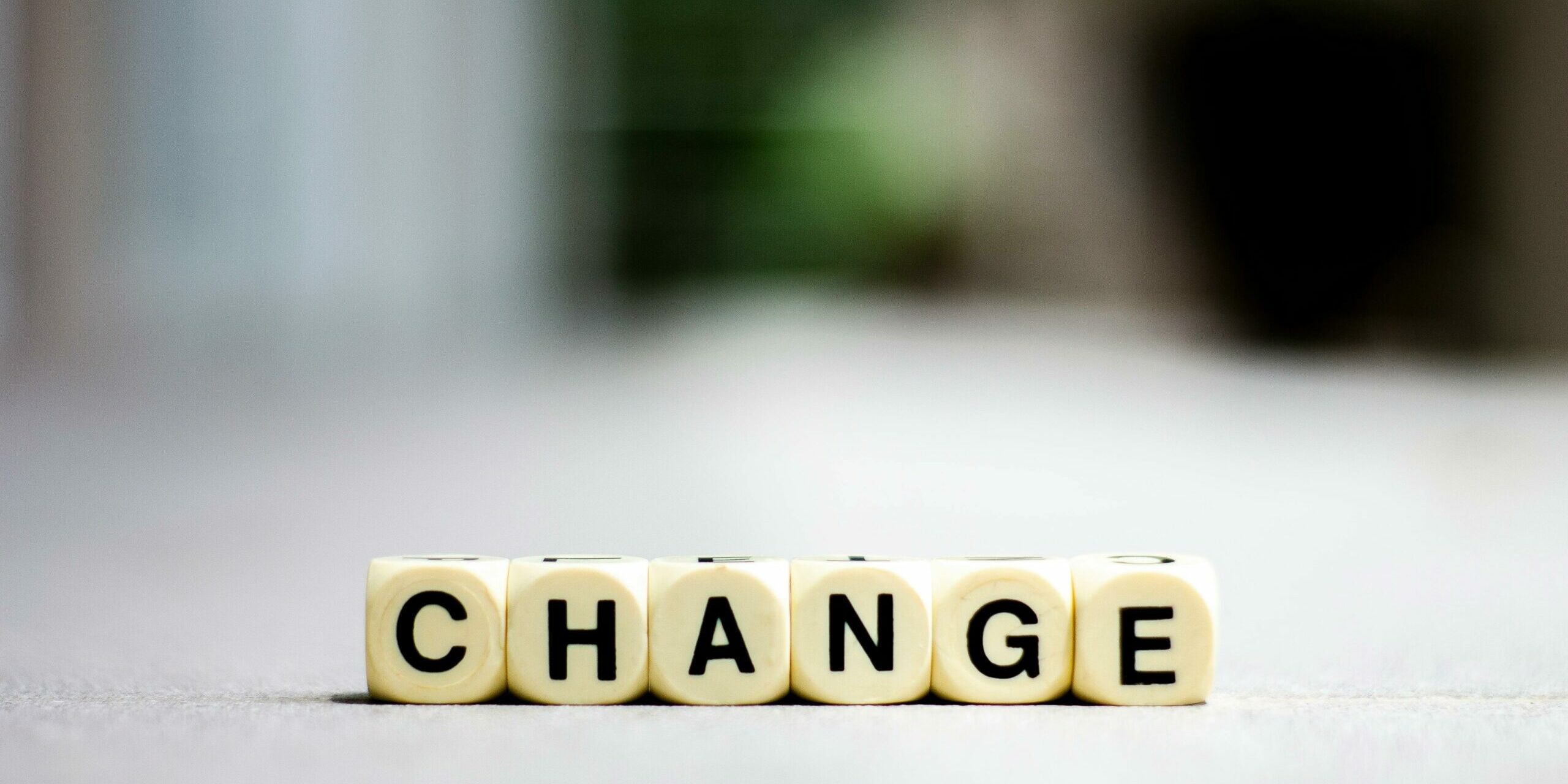 Change Scrabble dices aligned to make the word “change”